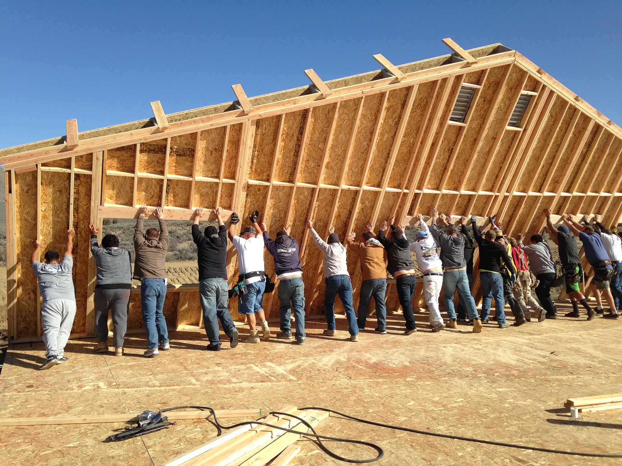 Reno home builders from the Lifestyle Homes holding up side of home to be built